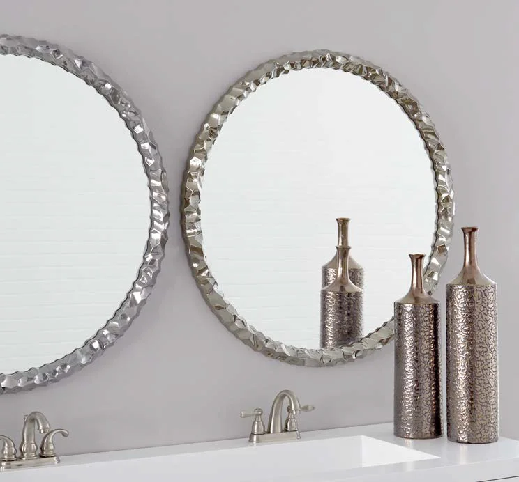 Two Round Mirrors on Purple Wall