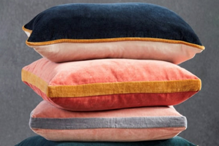 Stack of colorful pillows with different contrasting trim