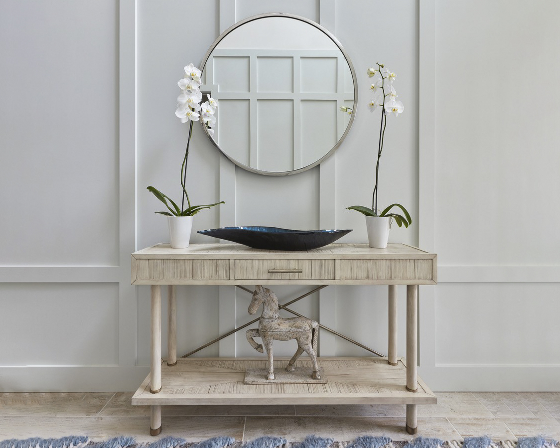 Round mirror with light wood entry table